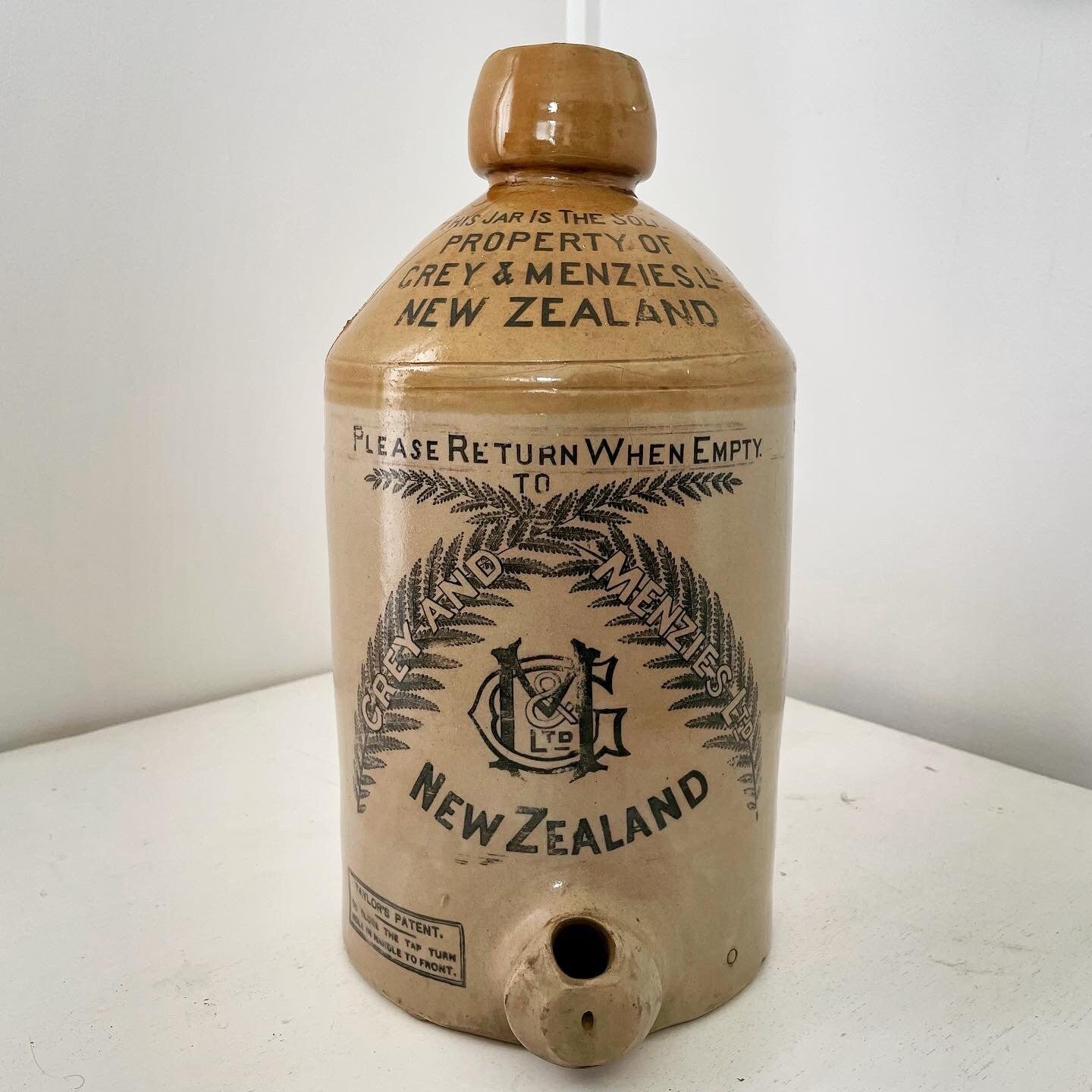 Extra large, antique stonewear jug stamped with New Zealand silver ferns