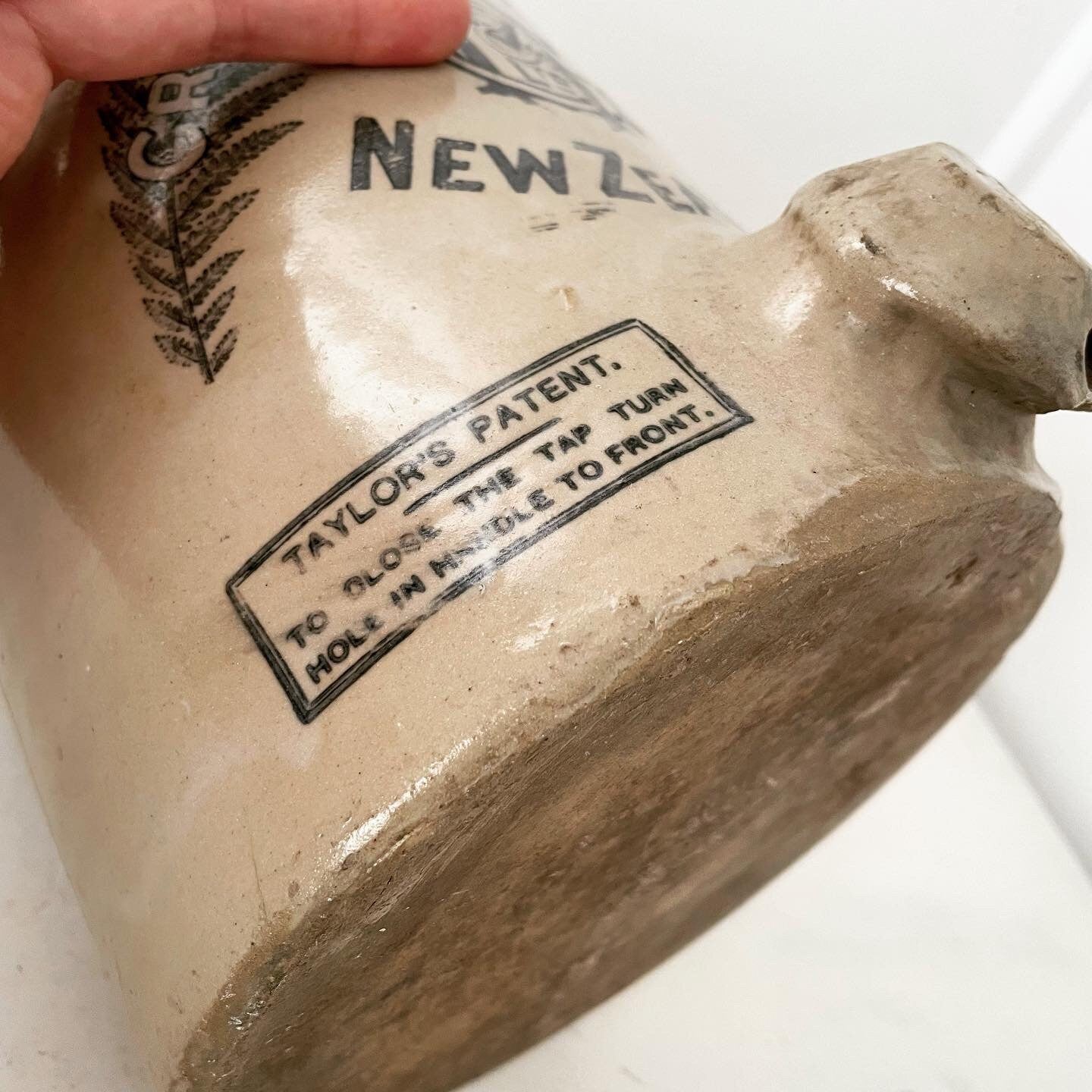 Extra large, antique stonewear jug stamped with New Zealand silver ferns