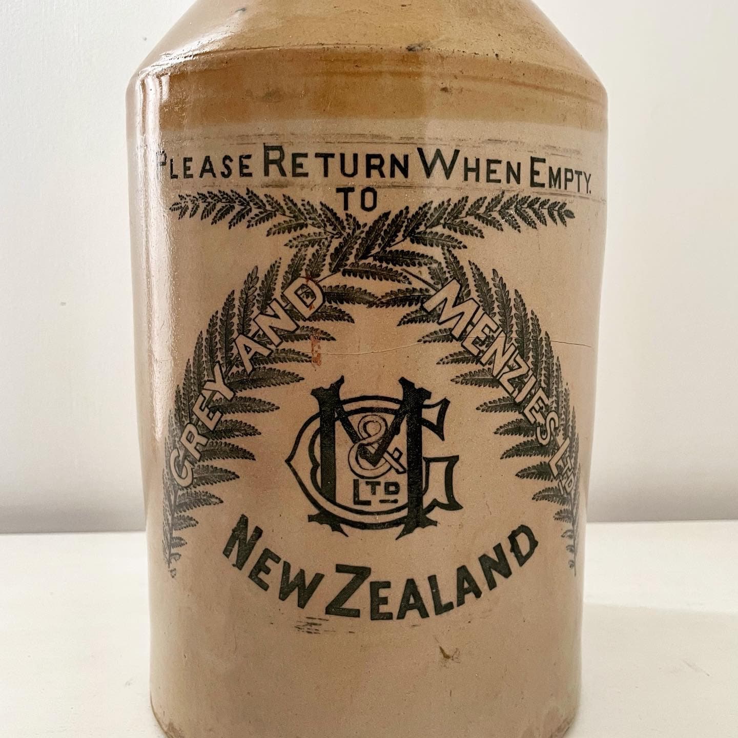 Extra large, antique stonewear jug stamped with New Zealand silver ferns