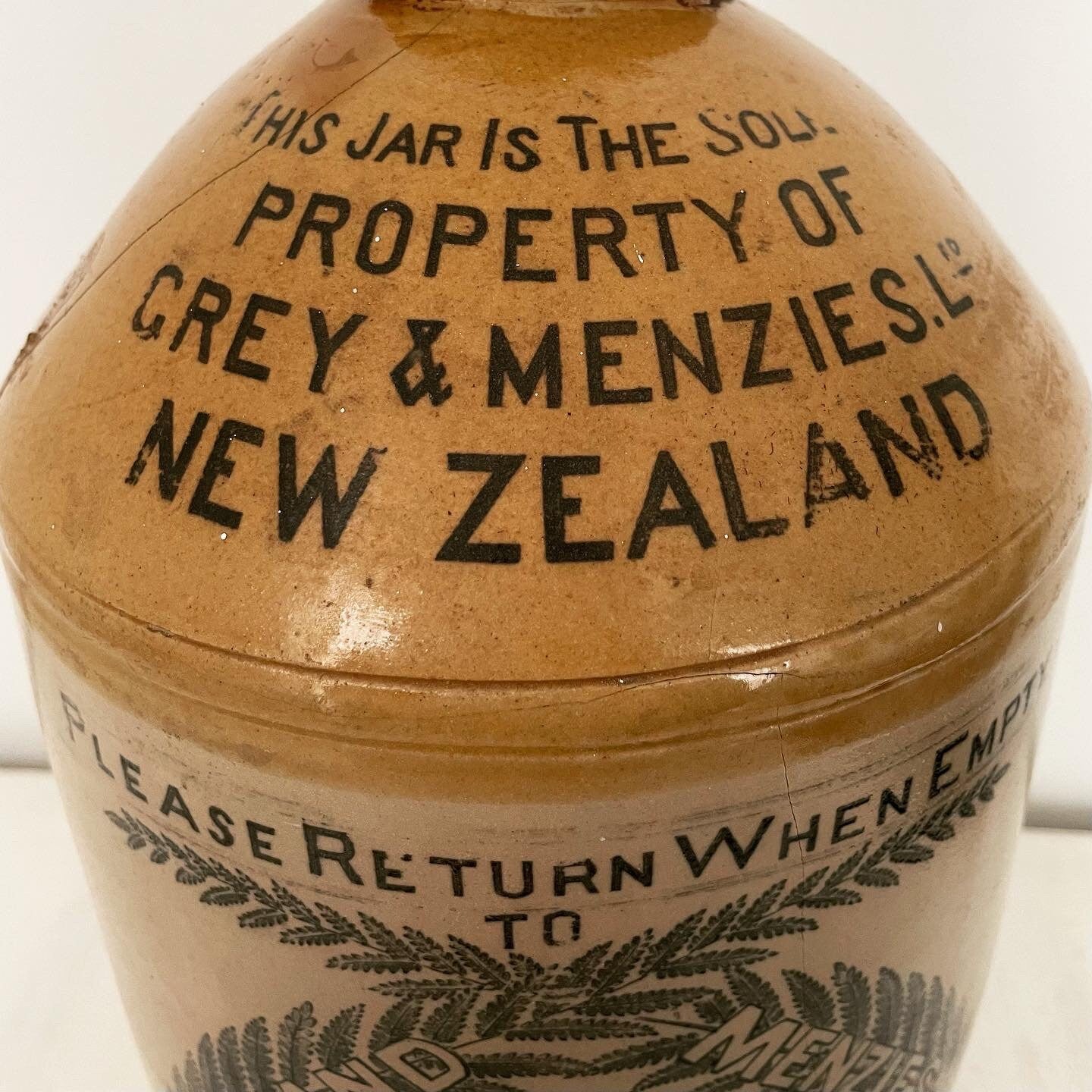 Extra large, antique stonewear jug stamped with New Zealand silver ferns
