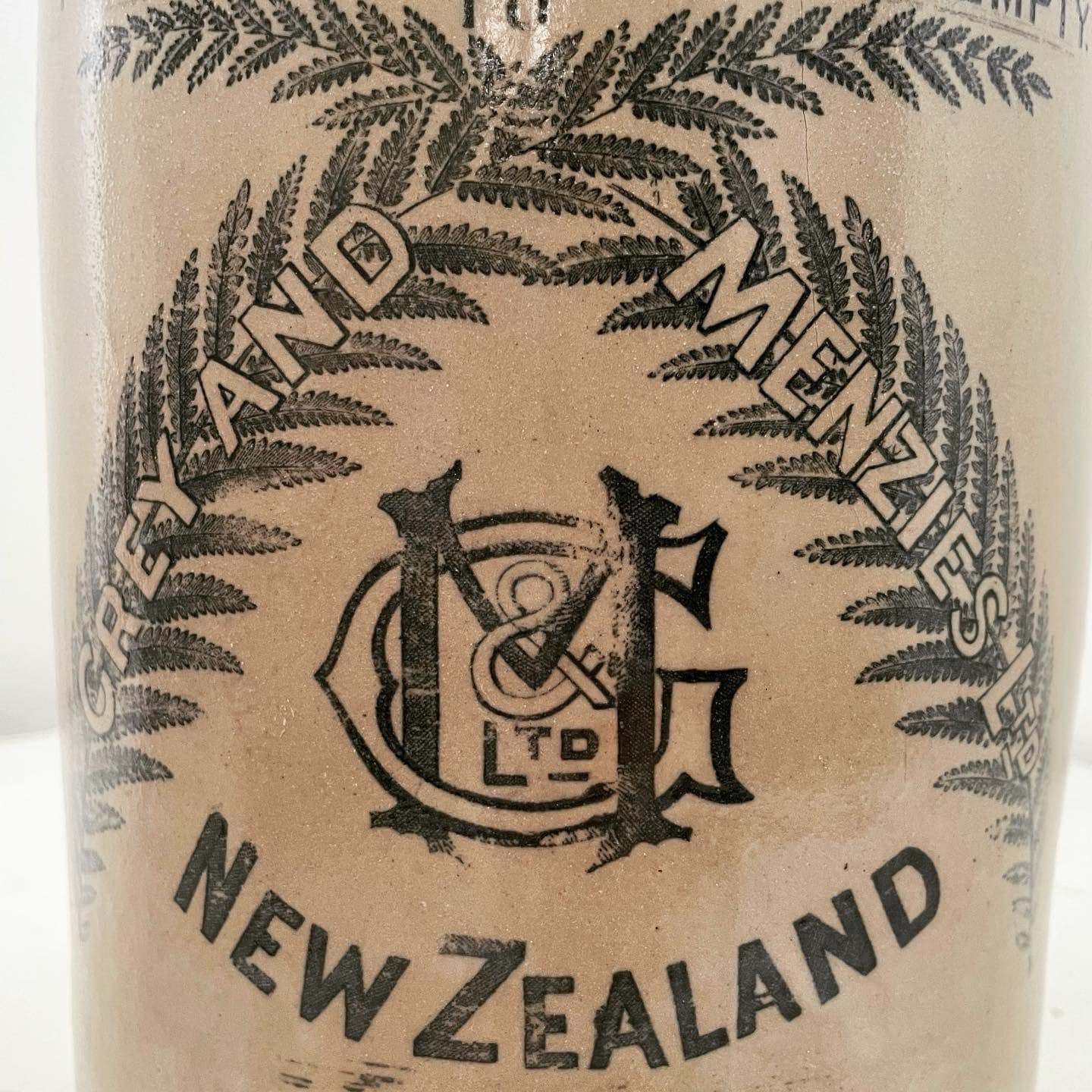 Extra large, antique stonewear jug stamped with New Zealand silver ferns
