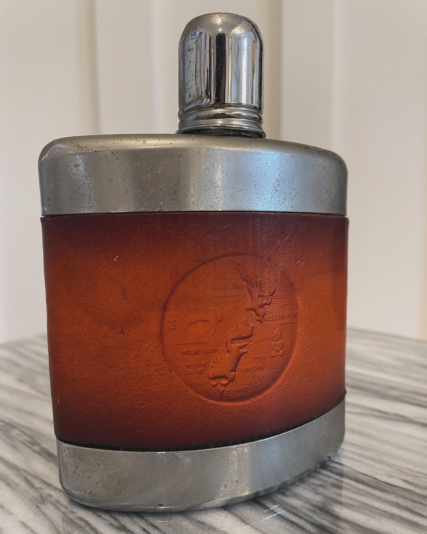 Vintage flask from New Zealand with embossed leather designs