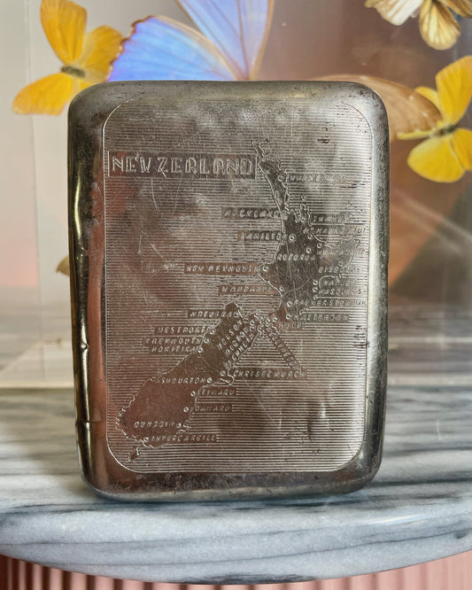 Antique tobacco tin with map of New Zealand engraved on the front