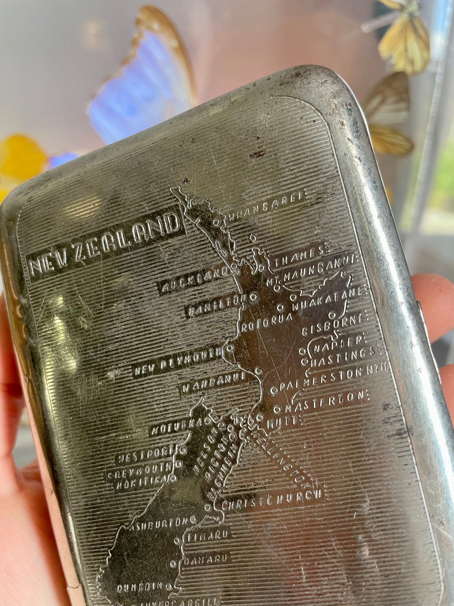 Antique tobacco tin with map of New Zealand engraved on the front