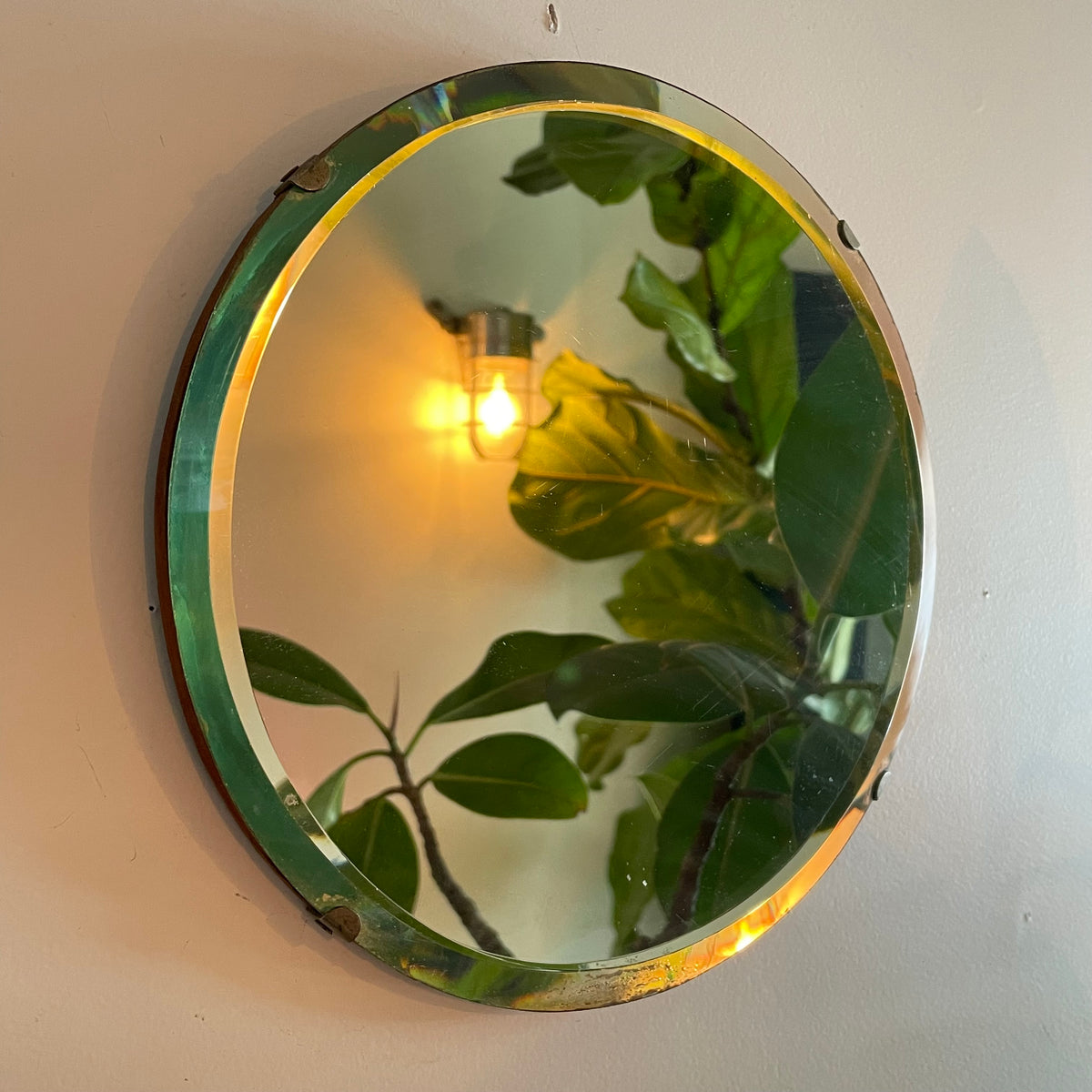 Small round antique mirror with rainbow catching beveles