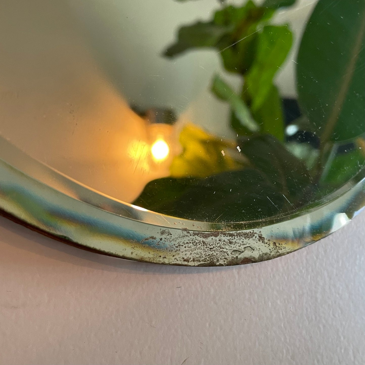 Small round antique mirror with rainbow catching beveles