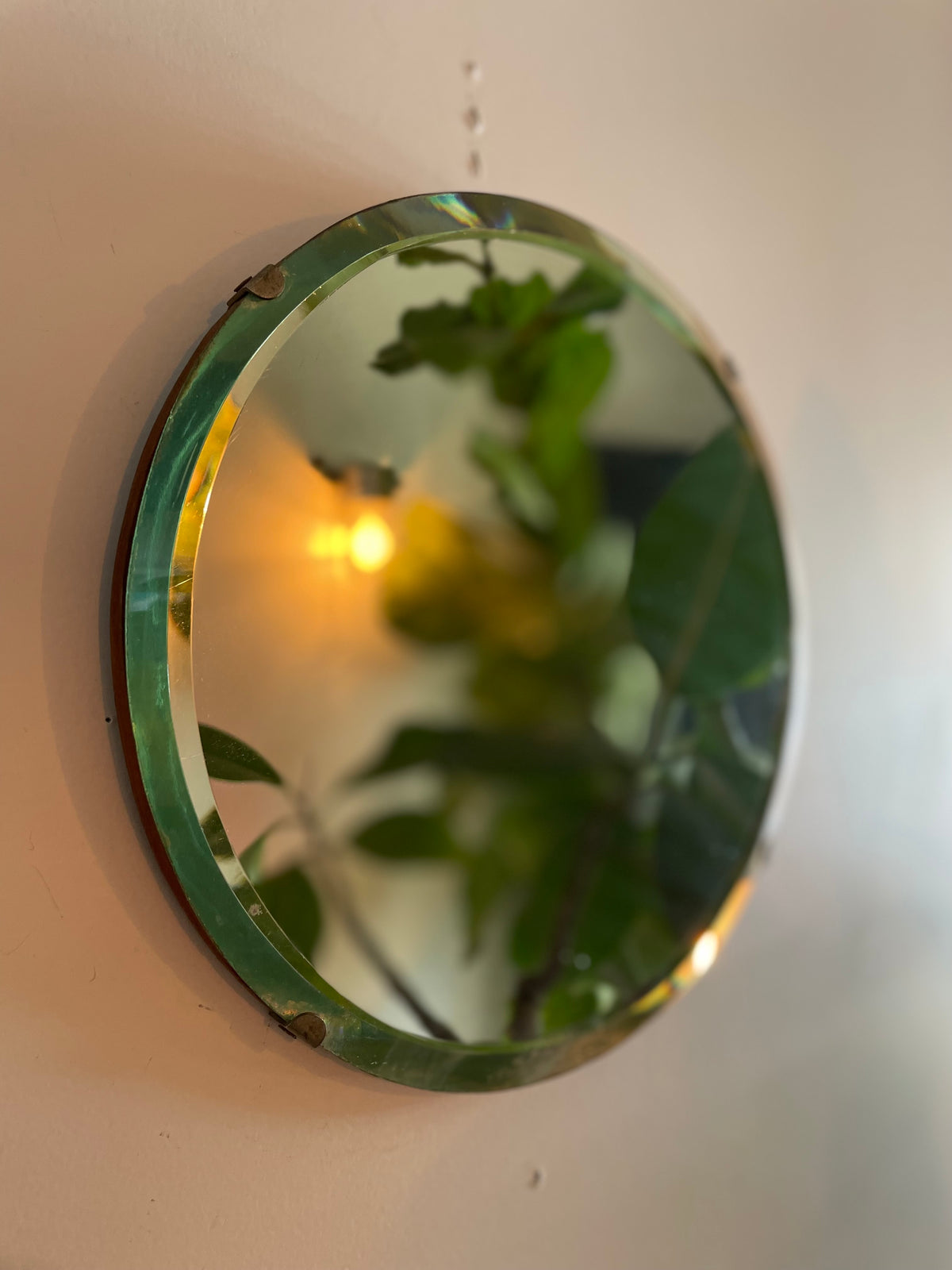 Small round antique mirror with rainbow catching beveles