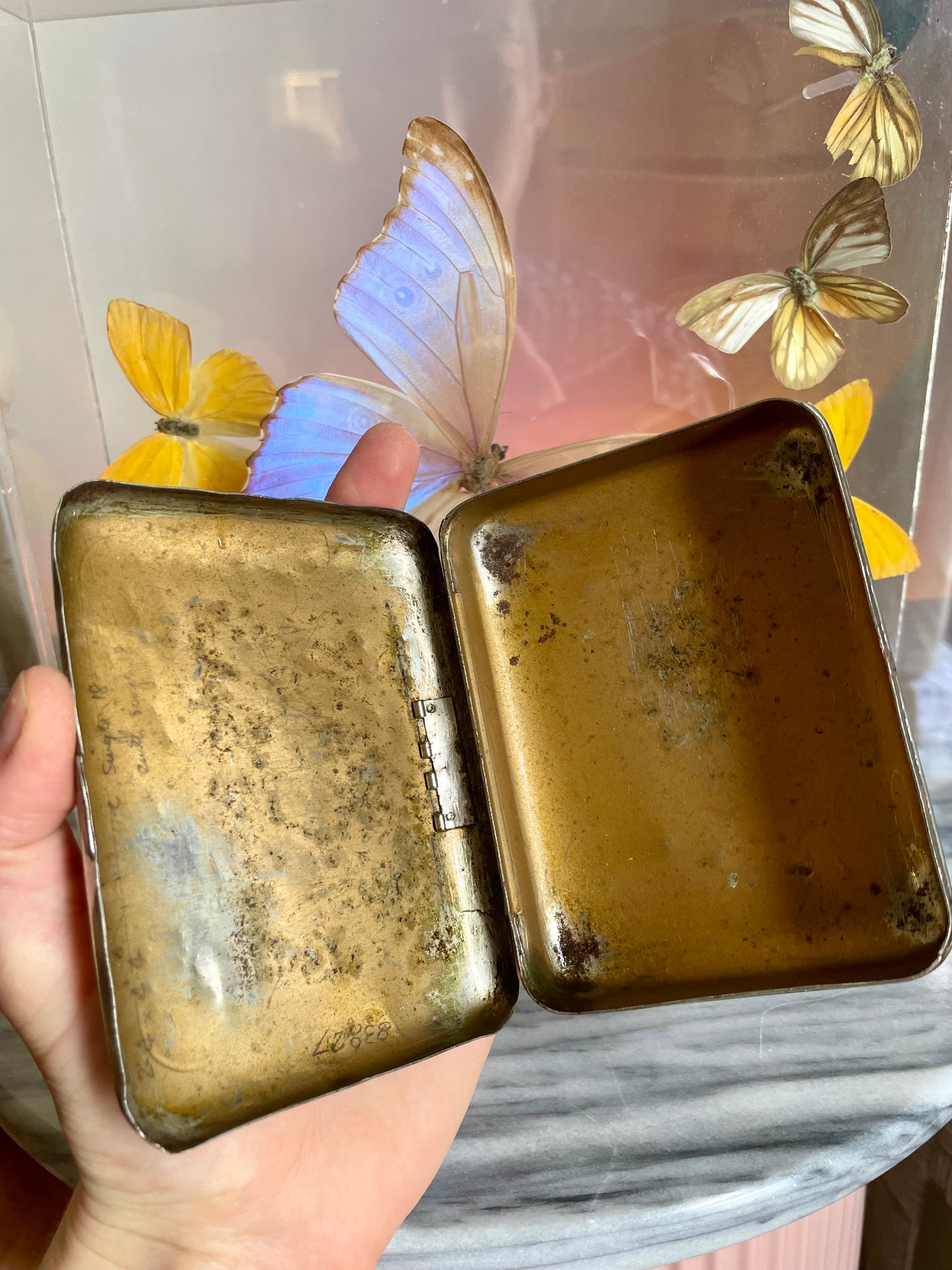 Antique tobacco tin with map of New Zealand engraved on the front
