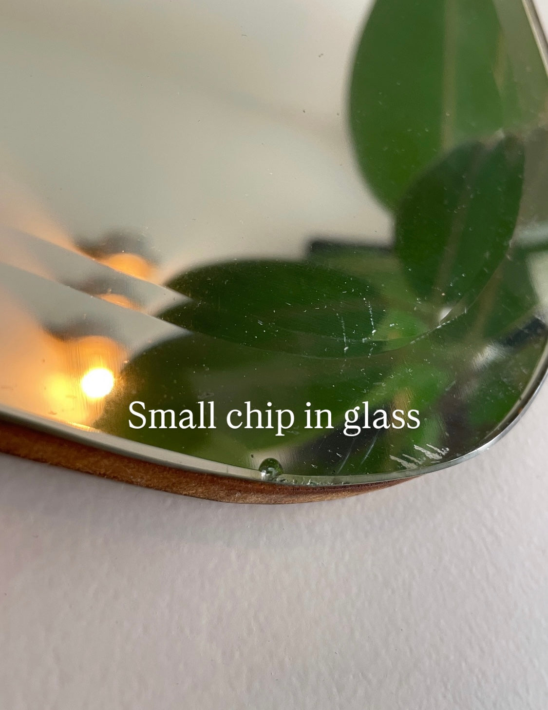 Antique 1930s Art Deco mirror with curving shape and thick beveled edges