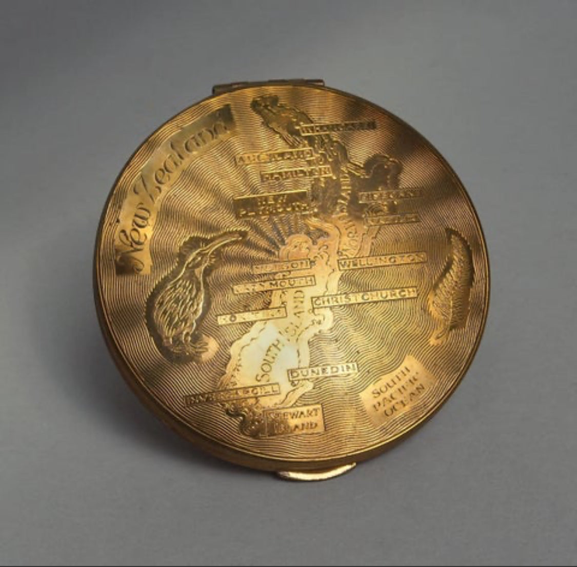Antique brass compact mirror engraved with kiwi and map of New Zealand - souvenir makeup powder compact