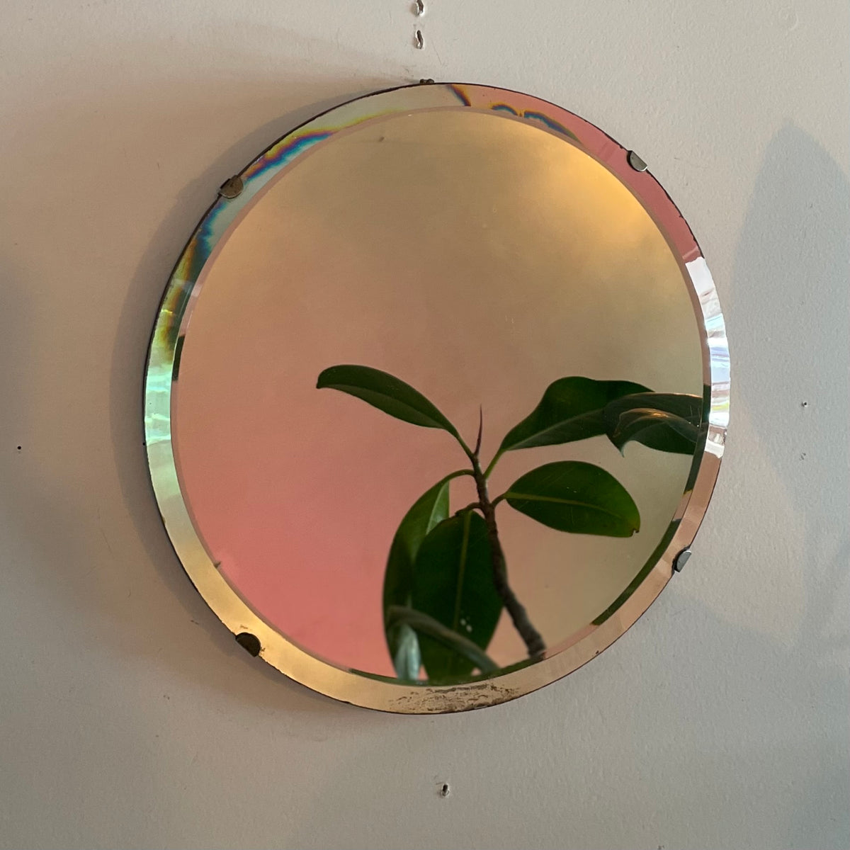 Small round antique mirror with rainbow catching beveles