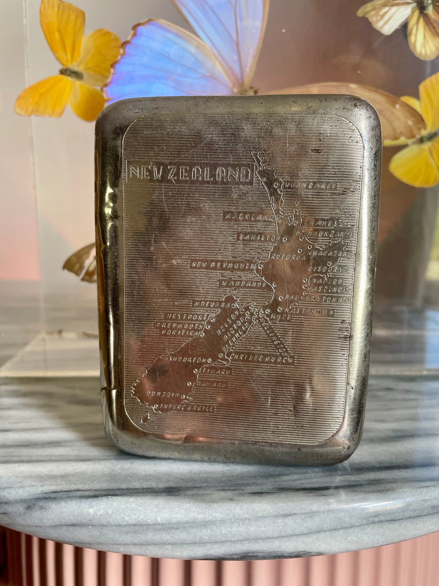 Antique tobacco tin with map of New Zealand engraved on the front
