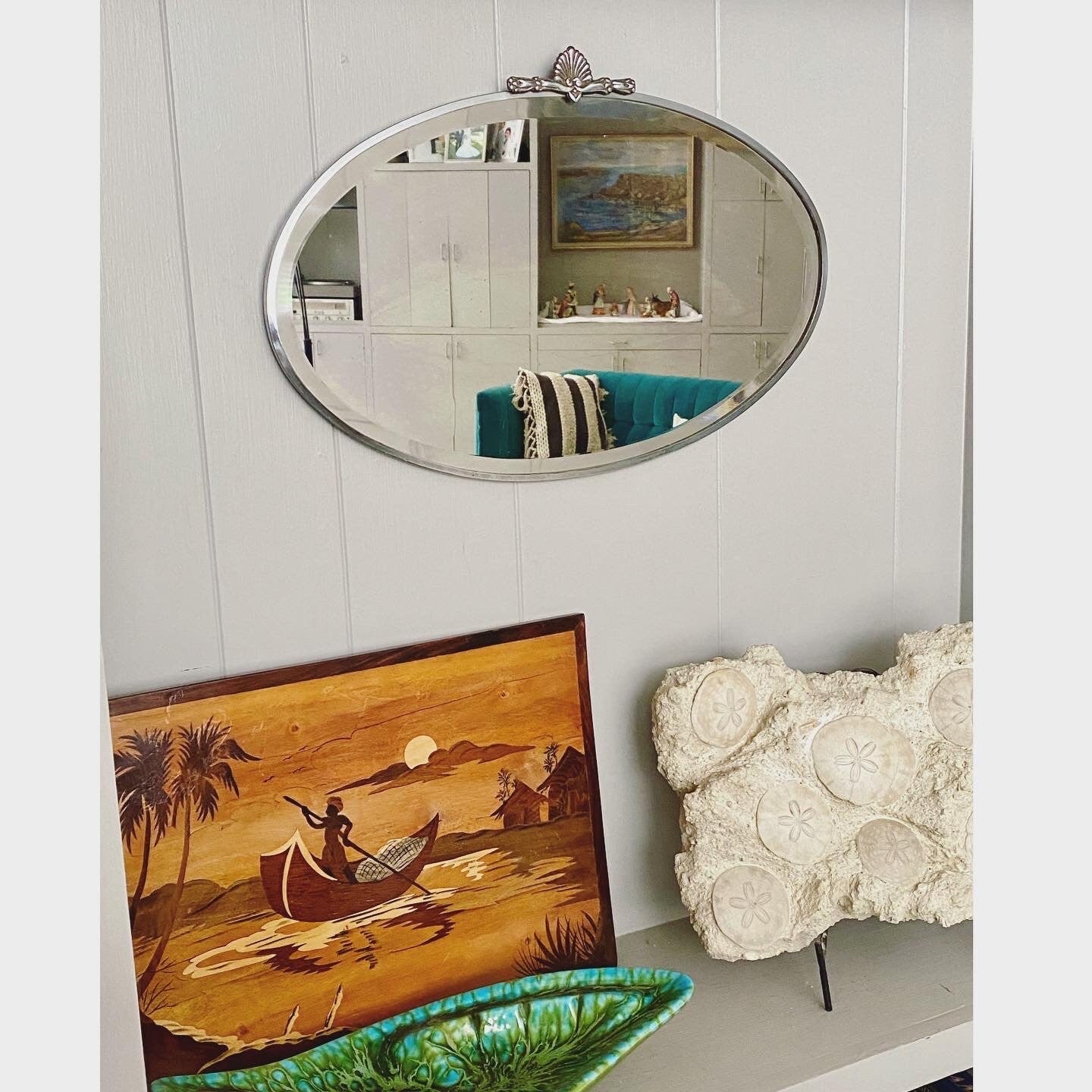 Art Deco beveled mirror with metal frame and decorative topper