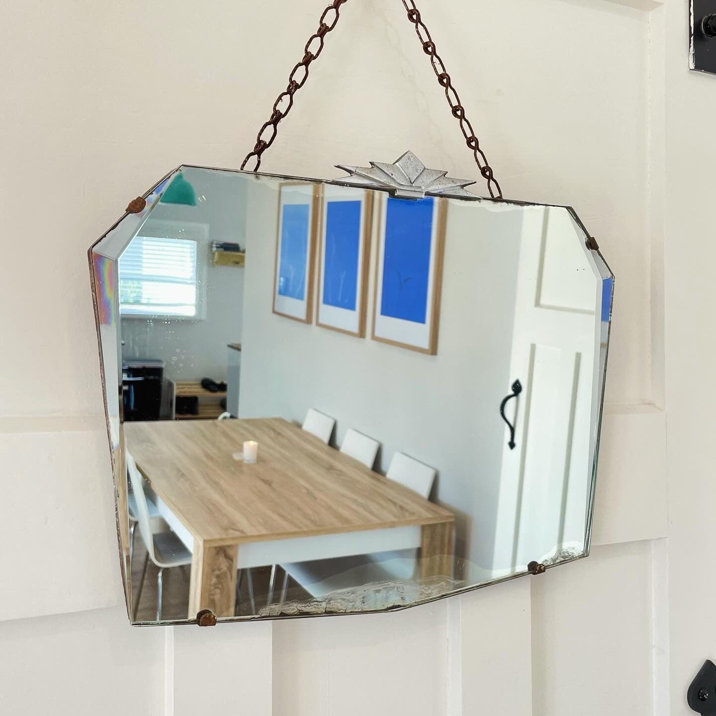 Frameless beveled mirror with Art Deco starburst metal topper