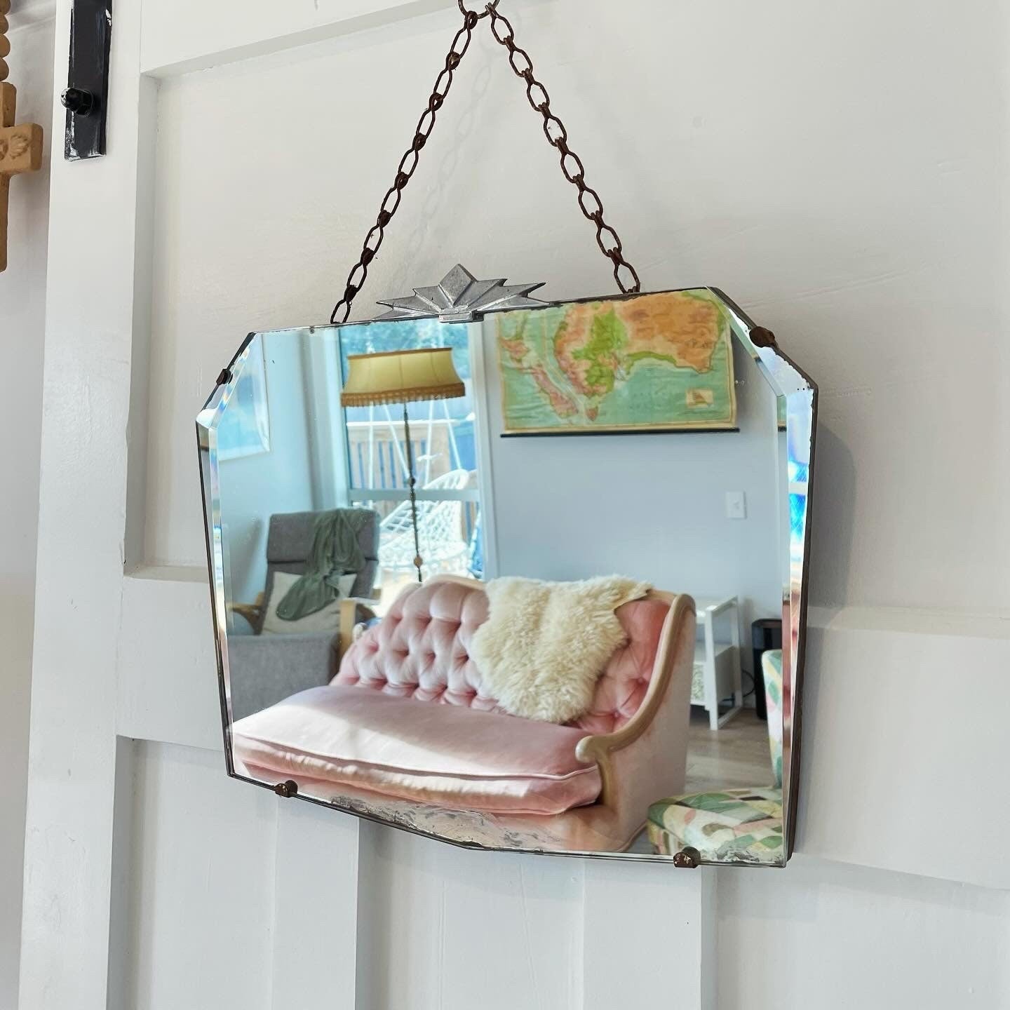 Frameless beveled mirror with Art Deco starburst metal topper