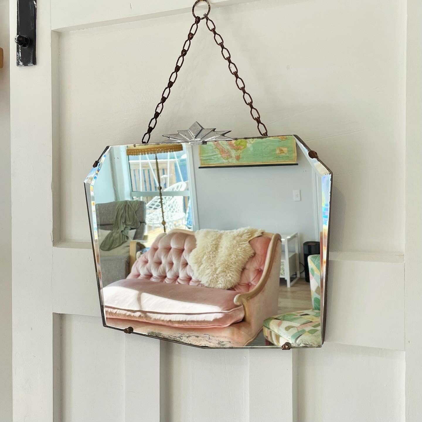 Frameless beveled mirror with Art Deco starburst metal topper