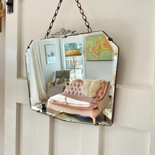 Frameless beveled mirror with Art Deco starburst metal topper